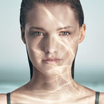 A female model immersed in water, representing the soothing and hydrating effects of Crème de La Mer Moisturizing Cream, White, known for its Miracle Broth formula.