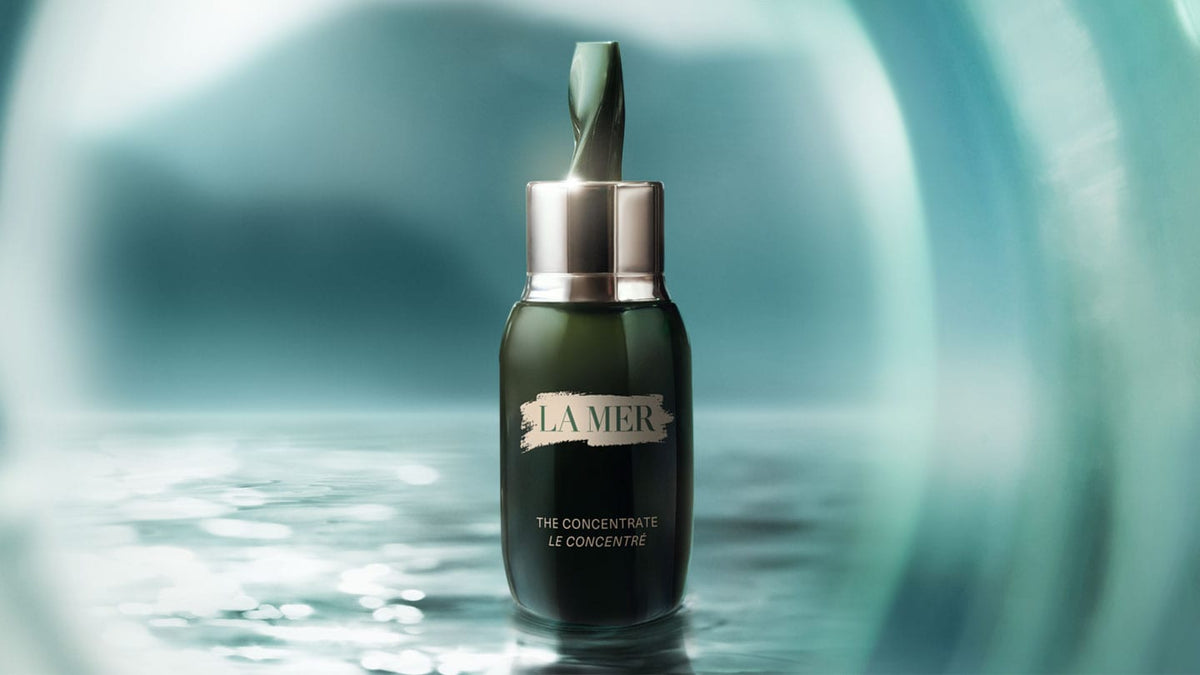 Wide view of Crème de La Mer Moisturizing Cream, White jar placed on a serene water surface, reflecting its deeply hydrating and soothing qualities for ultimate skin renewal.