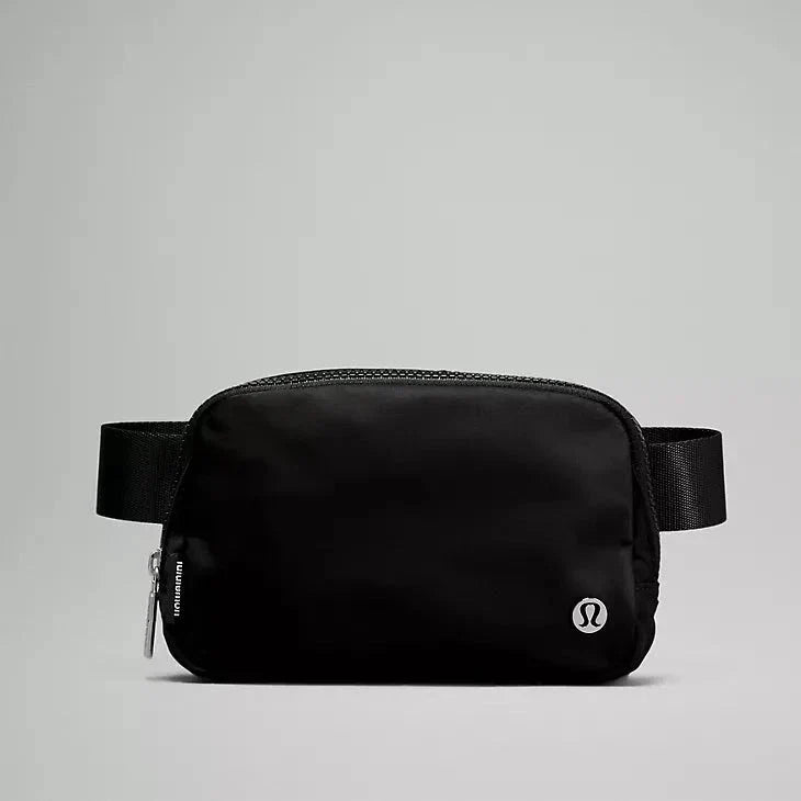 Front view of the Lululemon Everywhere Belt Bag 1L in Black, showcasing its sleek design and minimalist Lululemon logo, perfect for hands-free convenience and style.