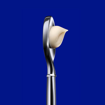 Close-up of La Prairie Skin Caviar Luxe Cream with its elegant applicator. This premium anti-aging cream is infused with caviar extract and micro-nutrients to rejuvenate and firm the skin, offering a luxurious skincare experience