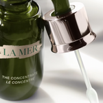 Side angle of Crème de La Mer Moisturizing Cream, White jar with cap, showing the elegant design and the nourishing cream known for reducing fine lines and improving skin texture.