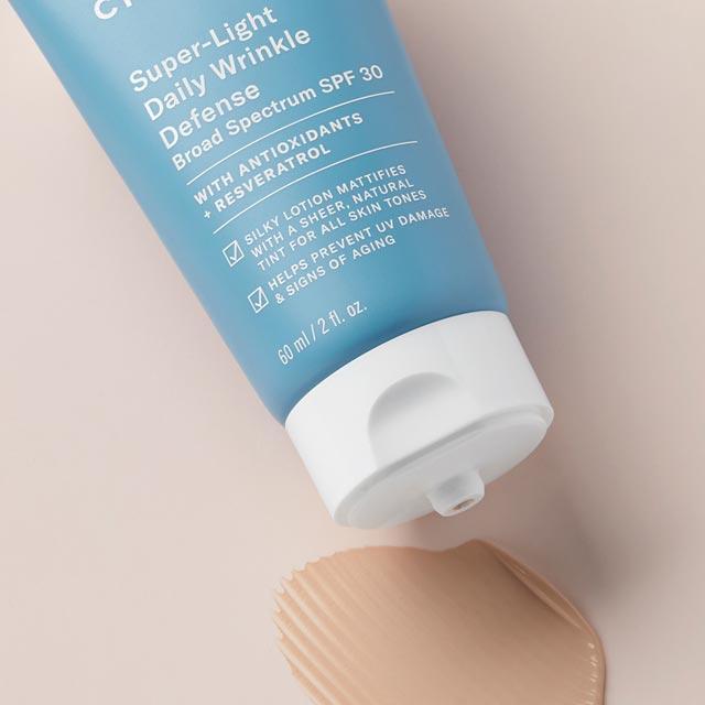 Paula's Choice Super-Light Wrinkle Defense SPF 30 tube with a small amount of cream squeezed out, highlighting its smooth, lightweight texture perfect for daily use.