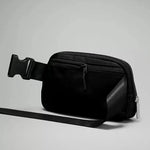Side view of the Lululemon Everywhere Belt Bag 1L in Black, highlighting its compact and sleek profile, perfect for carrying essentials without bulk.