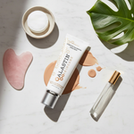 Alastin HydraTint Pro Mineral Sunscreen lifestyle flat lay